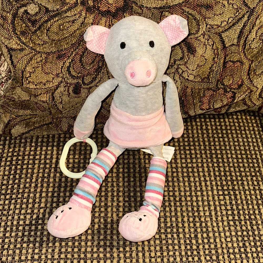 Infant Hanging Scentsy Buddy pig Wearing Leg Warmers and a Pink Skirt.